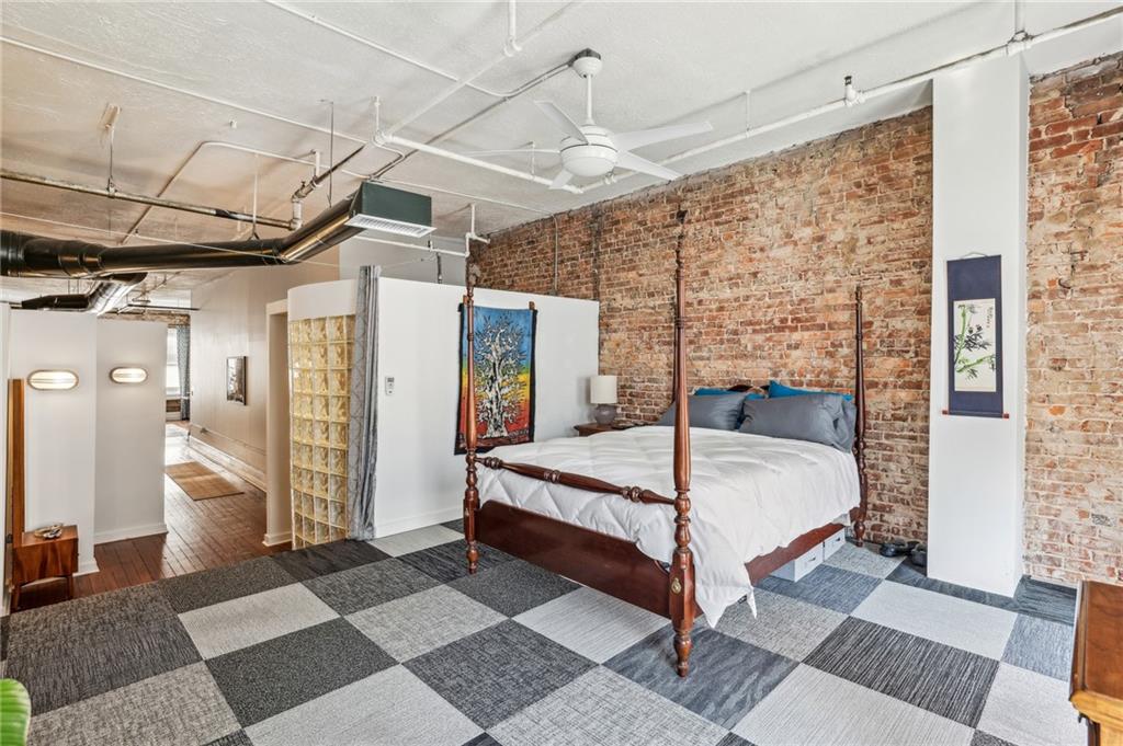 215 Mitchell Street Southwest, Unit 19 Atlanta, GA 30303 - Photo 7 of 29 a spacious bedroom with a bed and a mirror