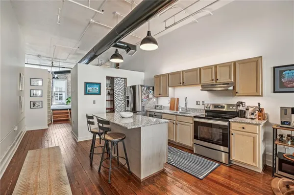 a kitchen with stainless steel appliances granite countertop a stove and a refrigerator