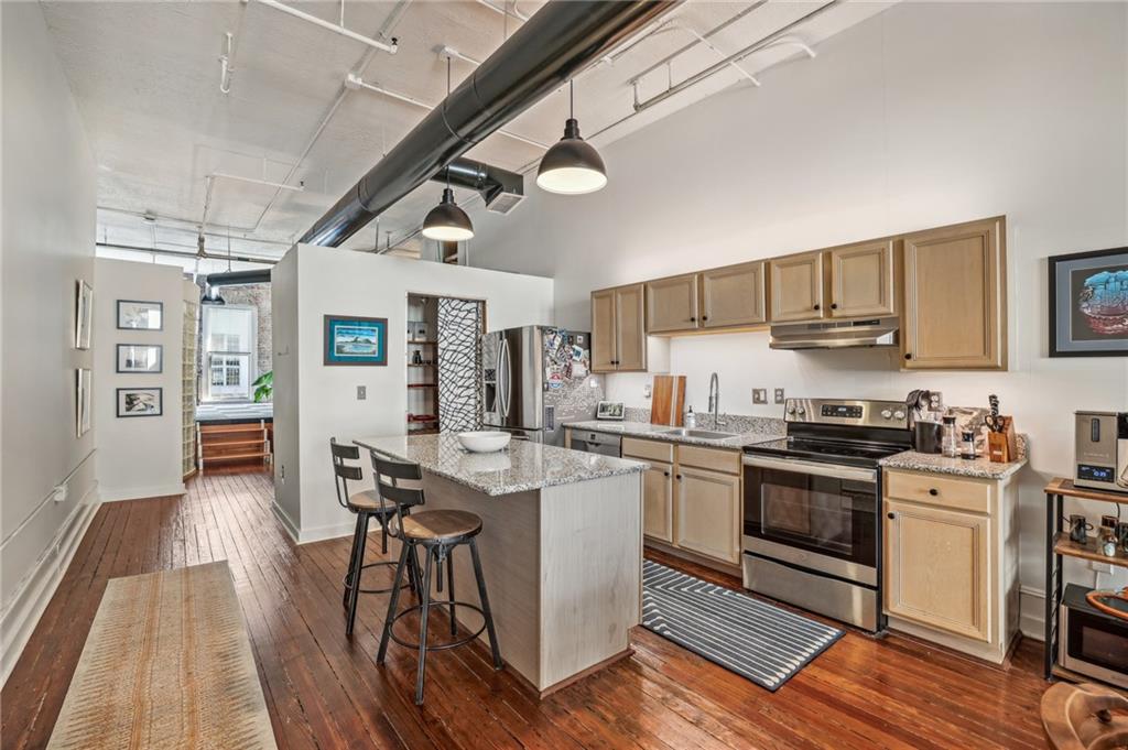 215 Mitchell Street Southwest, Unit 19 Atlanta, GA 30303 - Photo 10 of 29 a kitchen with stainless steel appliances granite countertop a stove and a refrigerator