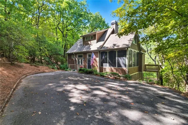 a front view of a house with yard and green space