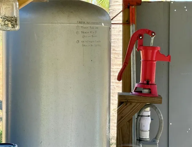 a view of a yard with plants and wooden fence