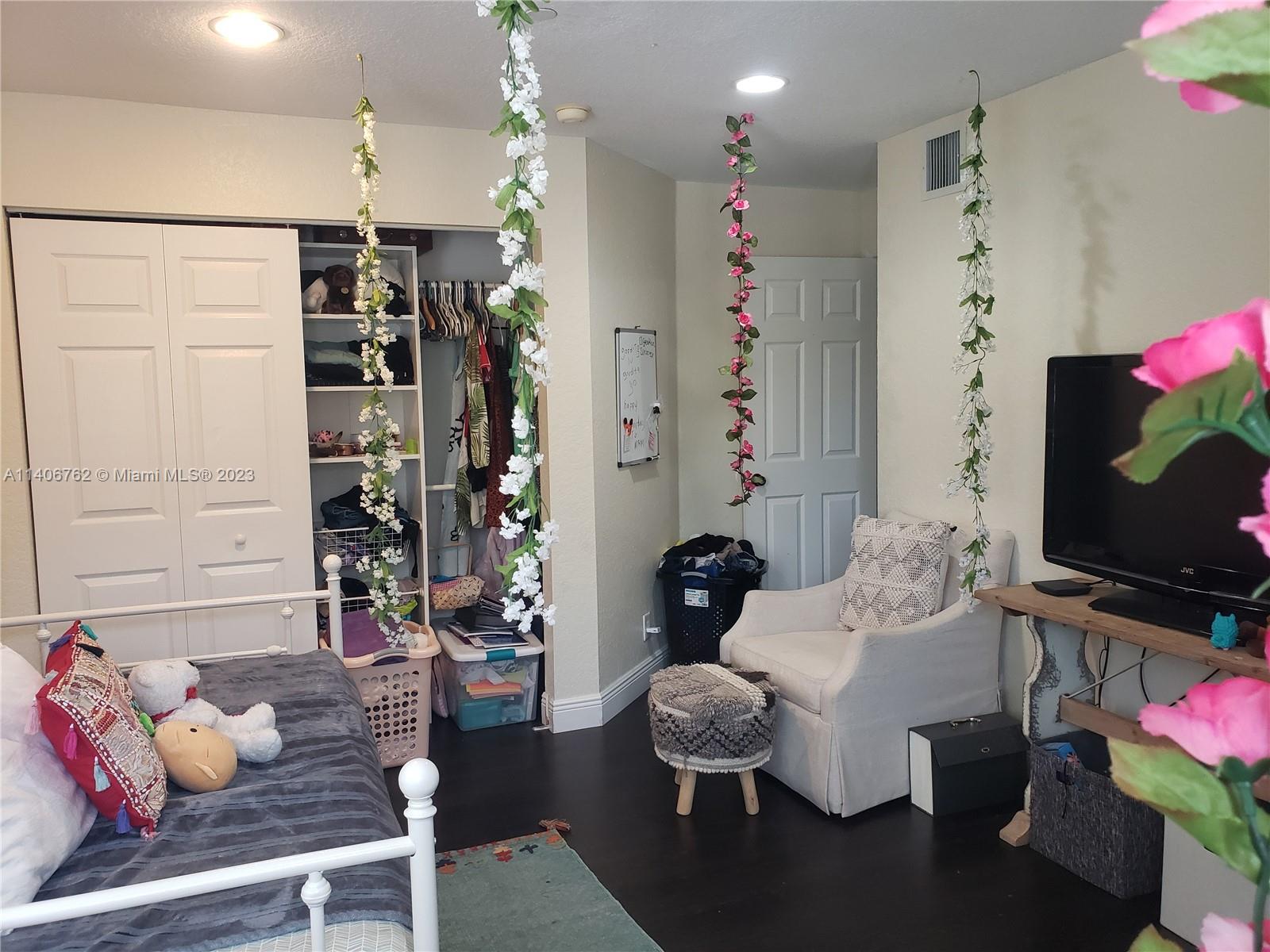 3933 Tree Top Drive, Unit 3933 Weston, FL 33332 - Photo 26 of 27 a living room with furniture and a flat screen tv