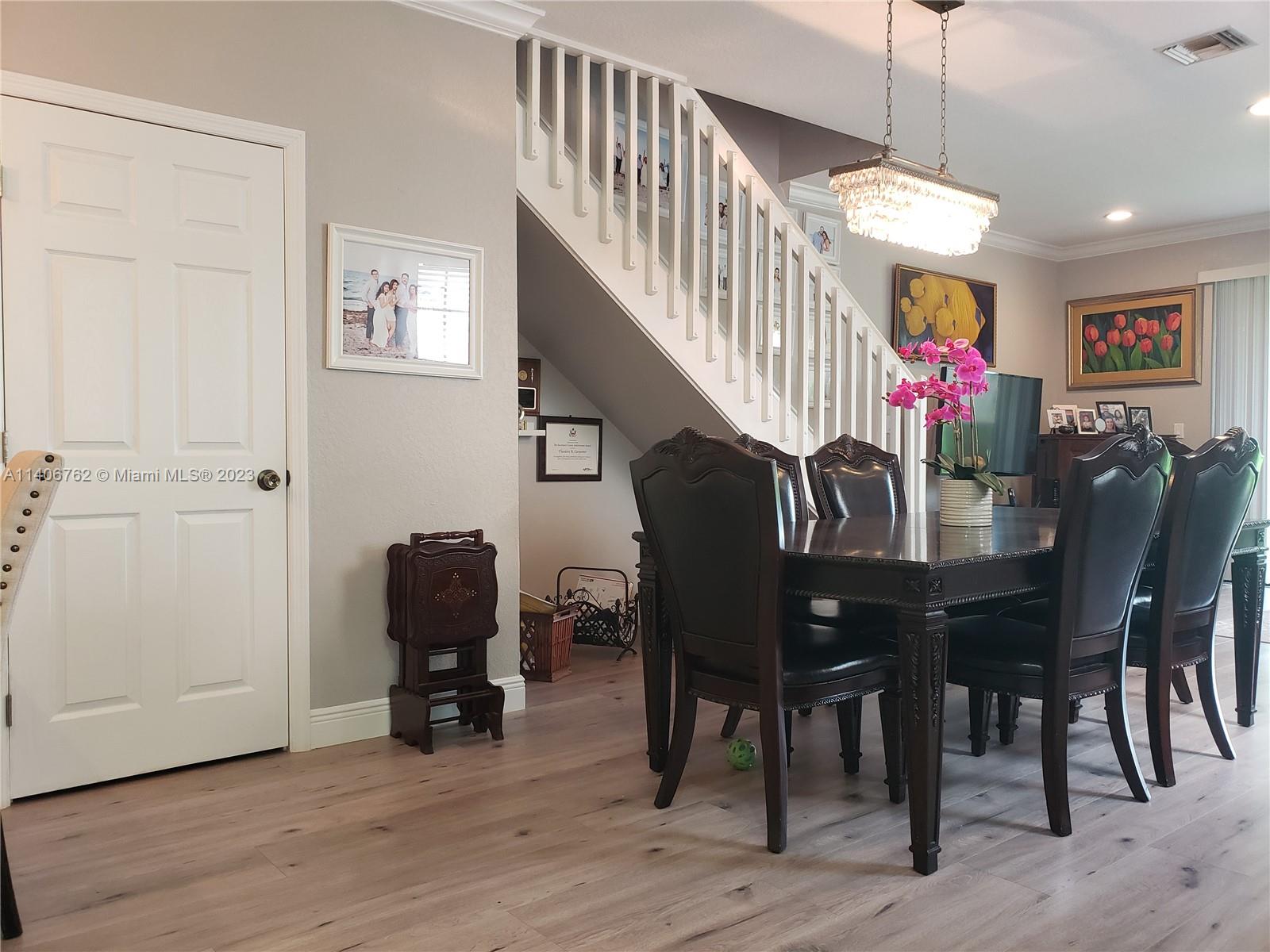 3933 Tree Top Drive, Unit 3933 Weston, FL 33332 - Photo 4 of 27 a view of a dining room with furniture and wooden floor