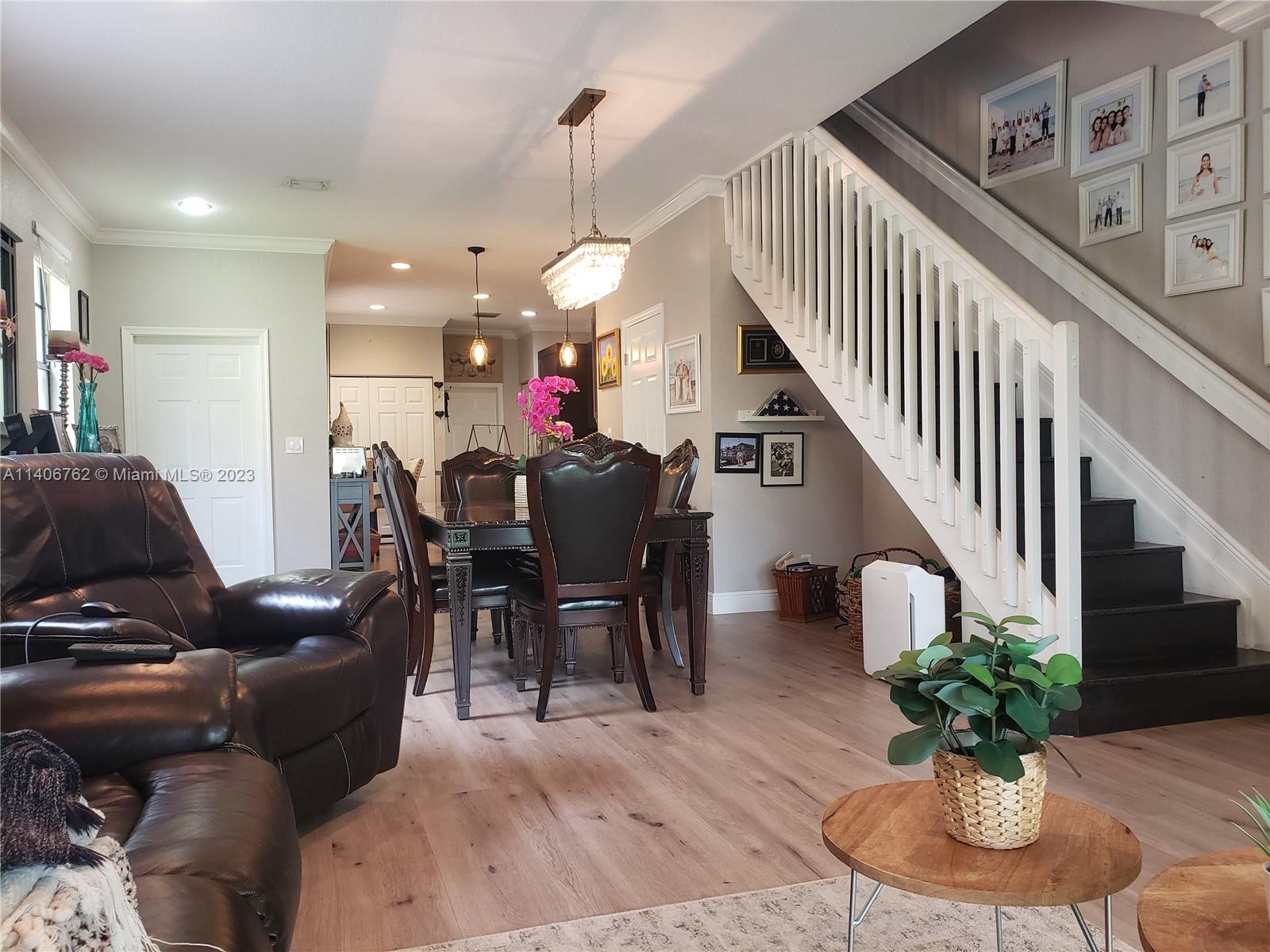 3933 Tree Top Drive, Unit 3933 Weston, FL 33332 - Photo 6 of 27 a dining room with furniture entryway and wooden floor