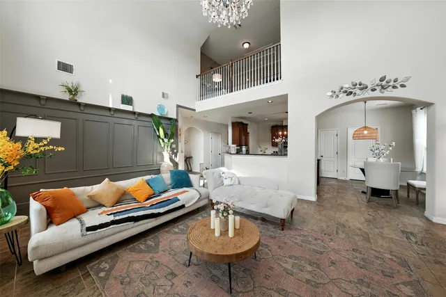 a living room with furniture and a chandelier
