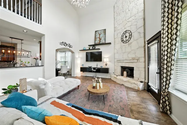 a living room with furniture a flat screen tv and a fireplace