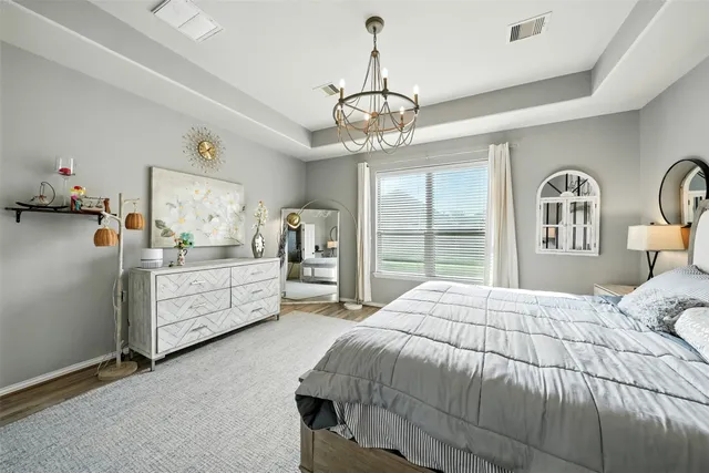 a bedroom with a large bed and ceiling fan