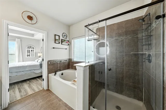 a bathroom with a bathtub and a shower