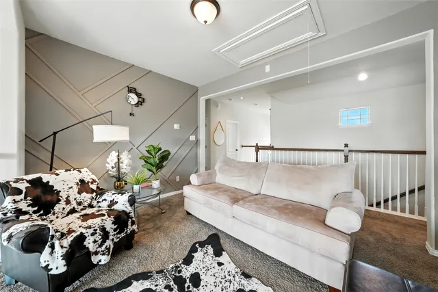 a living room with furniture flowers and a chandelier