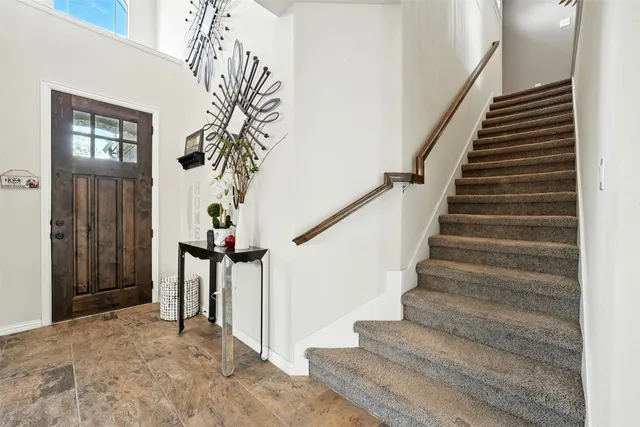 a view of entryway with a front door and wooden floor