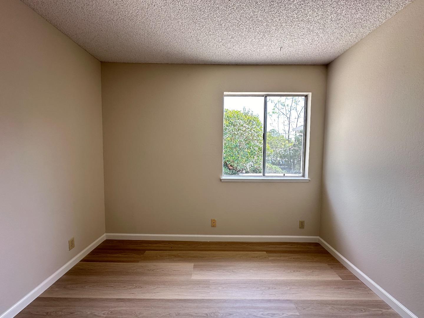 1710 Merrill Loop San Jose, CA 95124 - Photo 7 of 11 an empty room with wooden floor and window