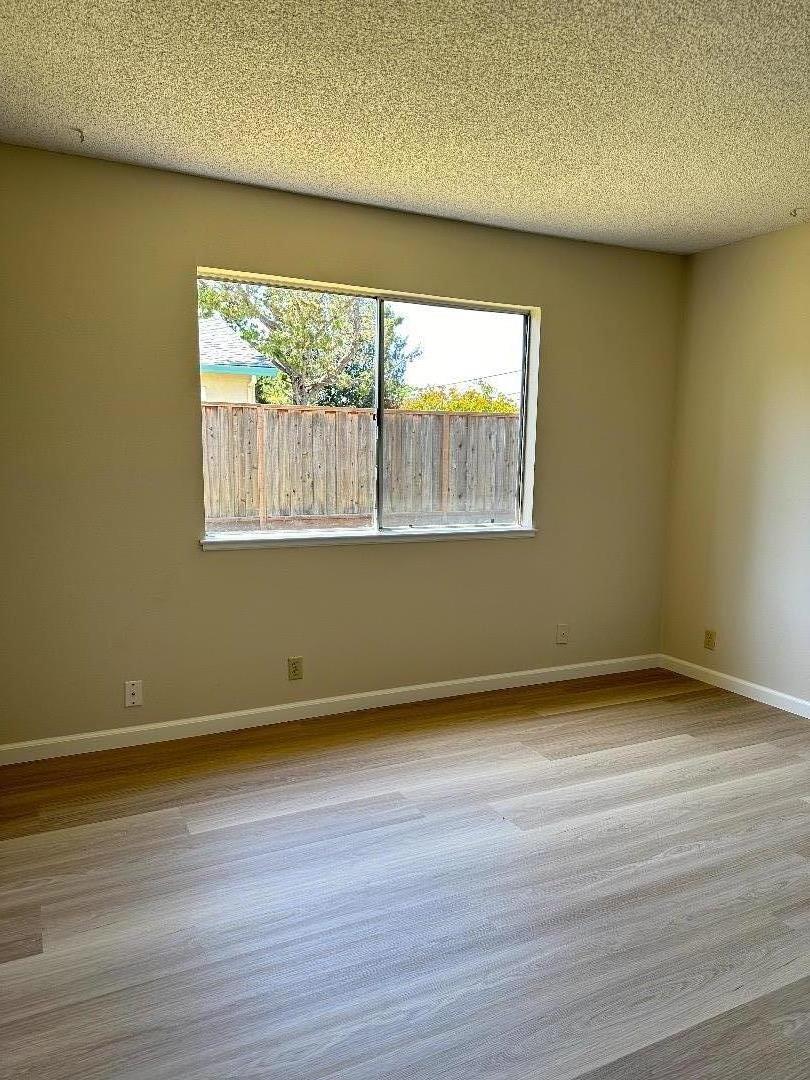 1710 Merrill Loop San Jose, CA 95124 - Photo 8 of 11 an empty room with wooden floor and windows