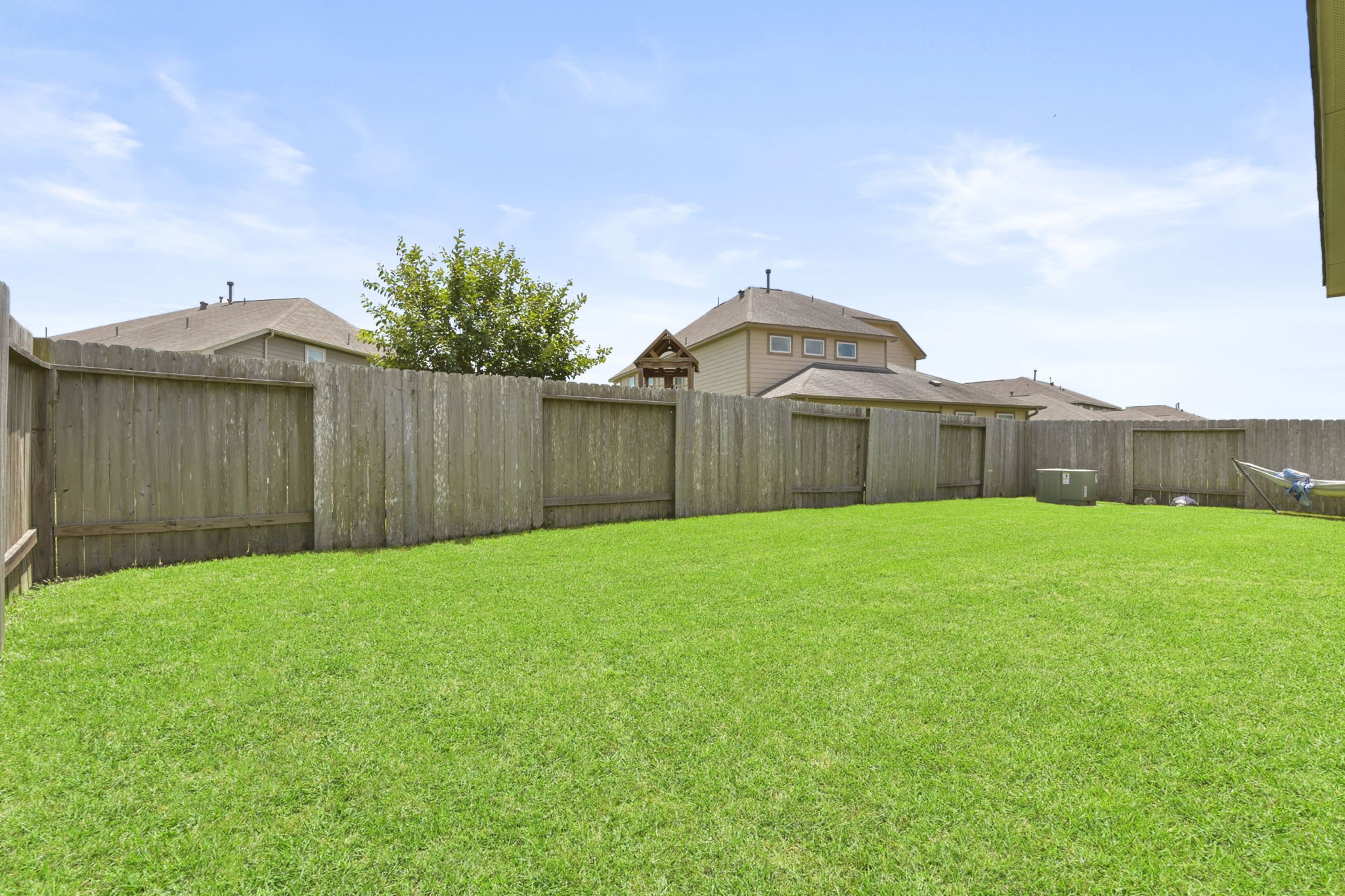 3011 Tandem Court Rosenberg, TX 77471 - Photo 28 of 29 a view of a backyard with table and chairs and wooden fence
