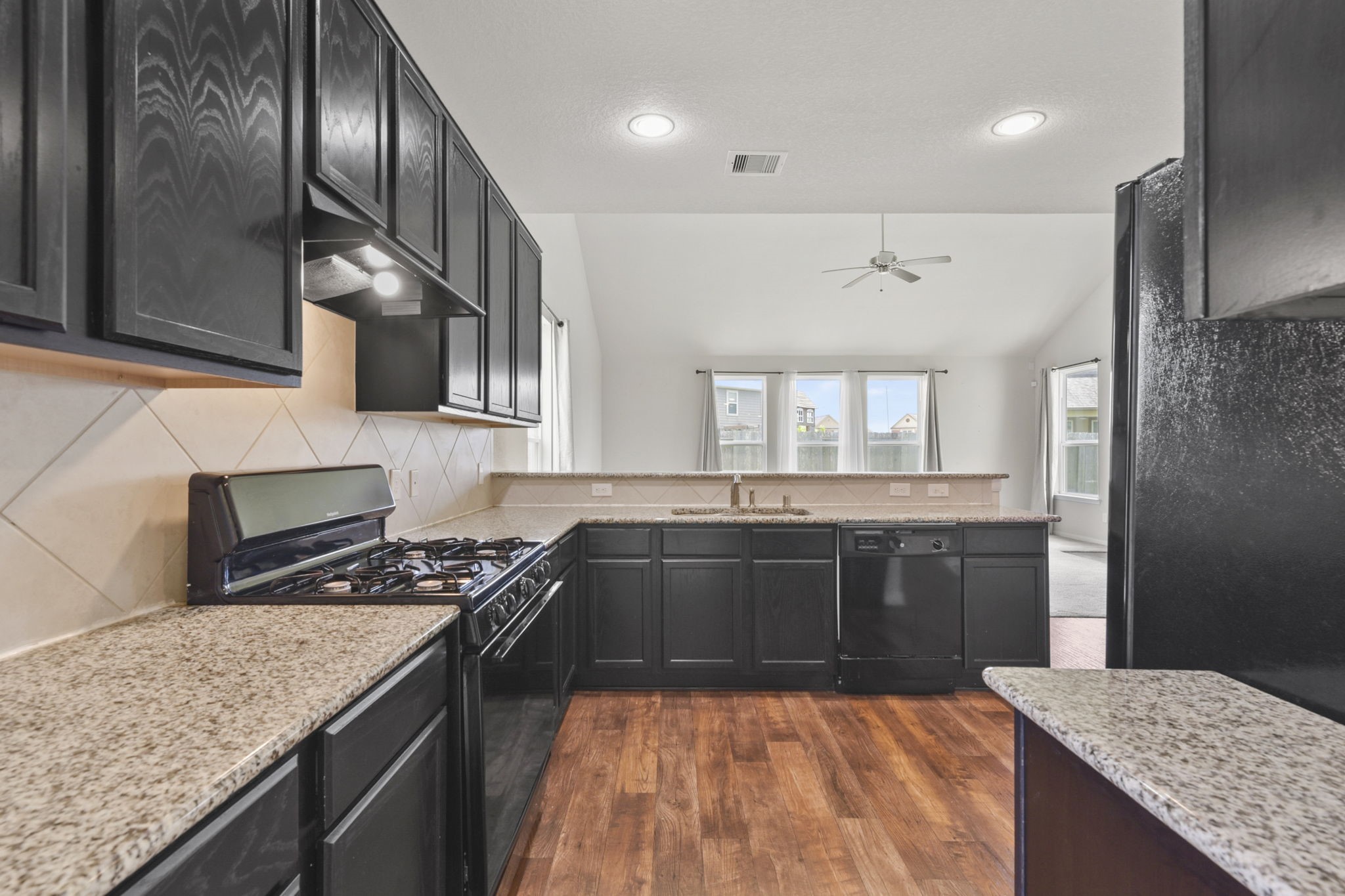 3011 Tandem Court Rosenberg, TX 77471 - Photo 6 of 29 a kitchen with stainless steel appliances granite countertop a sink stove and refrigerator