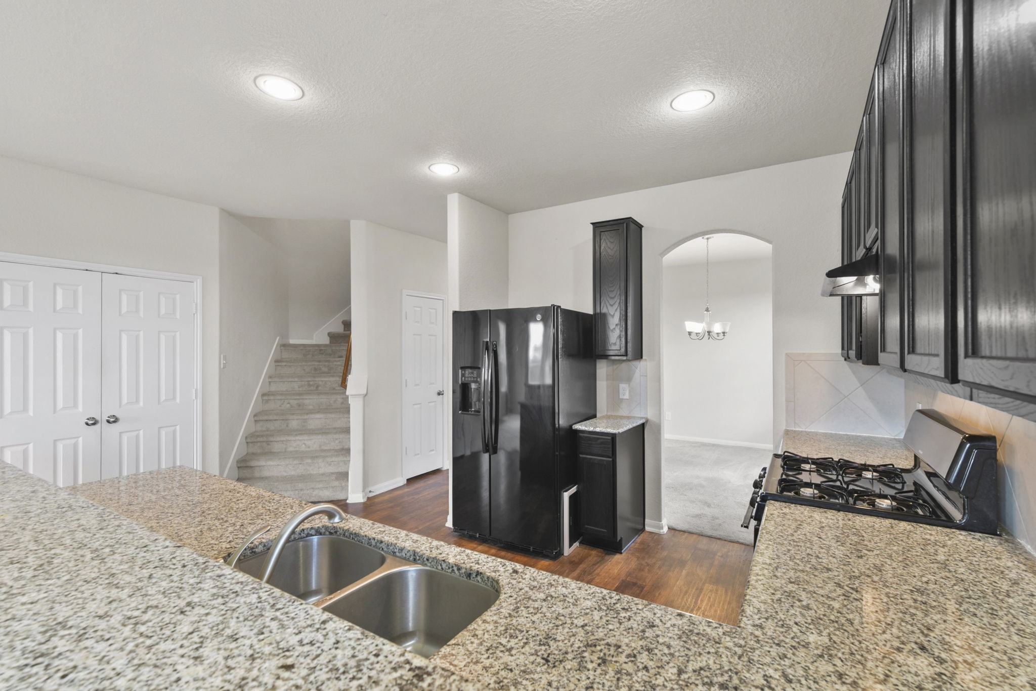 3011 Tandem Court Rosenberg, TX 77471 - Photo 8 of 29 a kitchen with stainless steel appliances kitchen island granite countertop a refrigerator a sink a stove and island