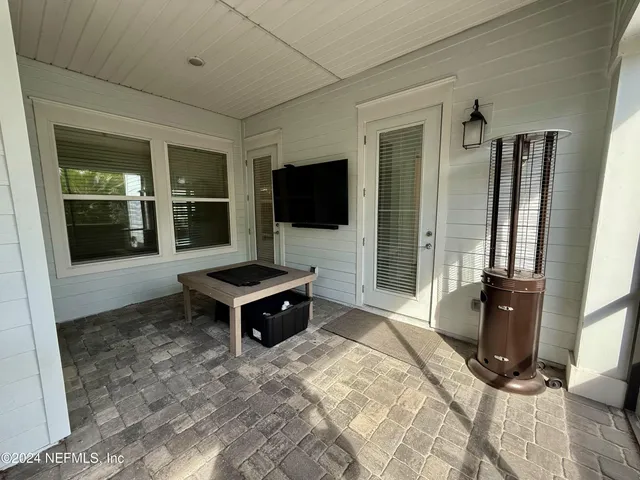a living room with granite countertop couches and flat screen tv