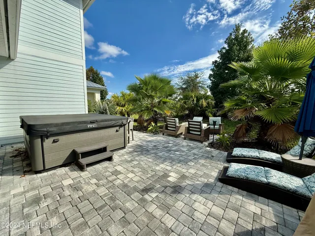 a swimming pool with outdoor seating and plants