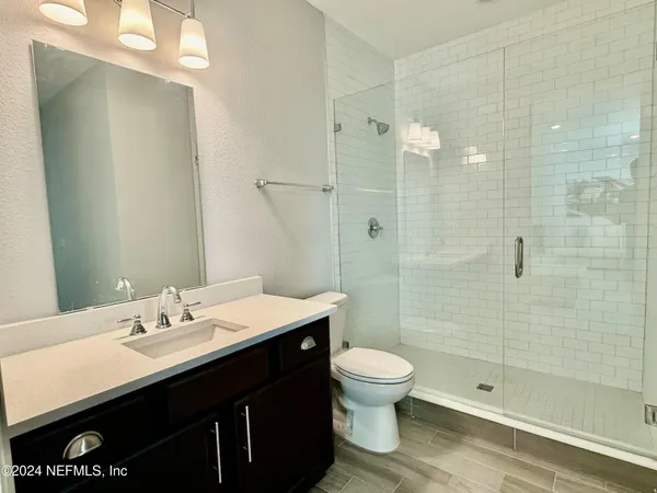 a bathroom with a sink shower and a toilet