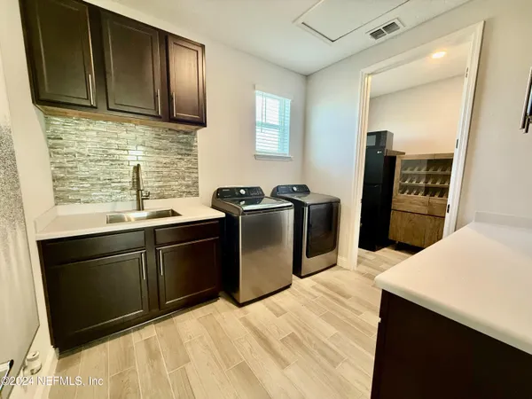 a kitchen with stainless steel appliances kitchen island granite countertop a refrigerator stove and sink