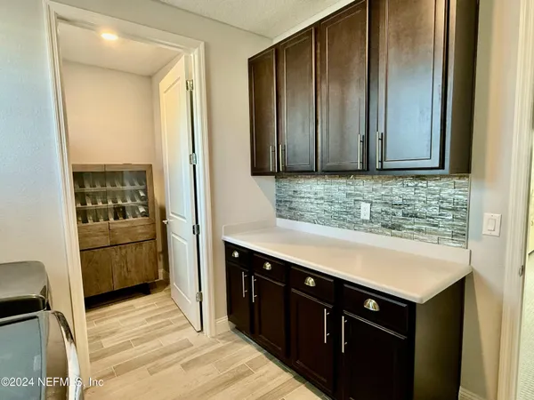 a kitchen with stainless steel appliances a sink stove and cabinets