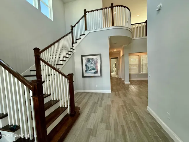 a view of staircase with railing and wooden floor