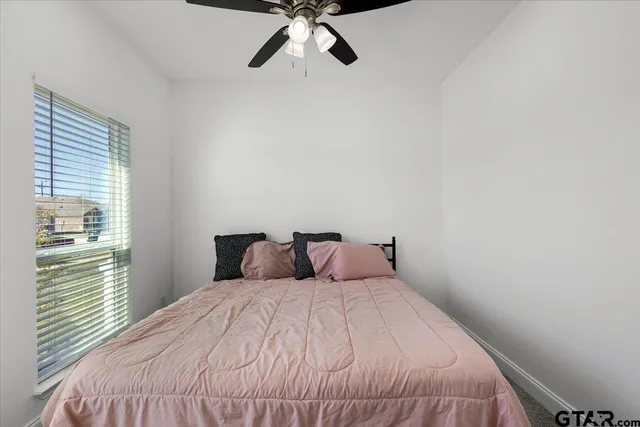 a bedroom with a bed and a window