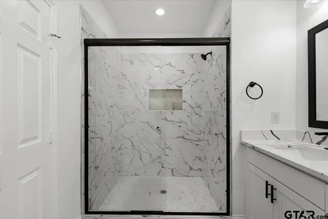 a bathroom with a shower and a sink