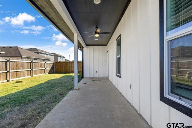 a view of a porch with a big yard and large trees