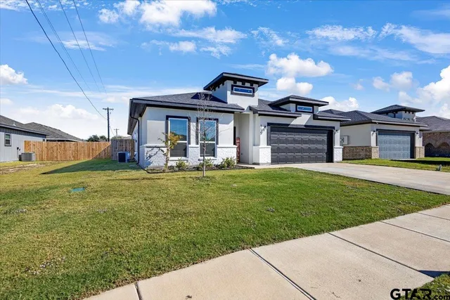 a front view of a house with a garden