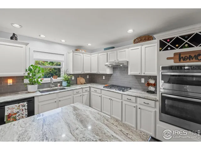 a kitchen with stainless steel appliances granite countertop a stove and a sink