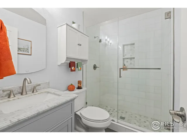 a bathroom with a granite countertop toilet sink and shower