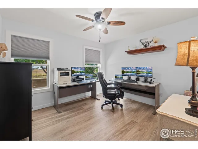 a workspace with wooden floor and a window
