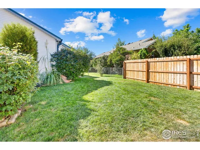 a view of a backyard with sitting area