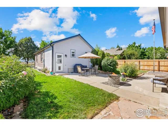 a view of a backyard with sitting area