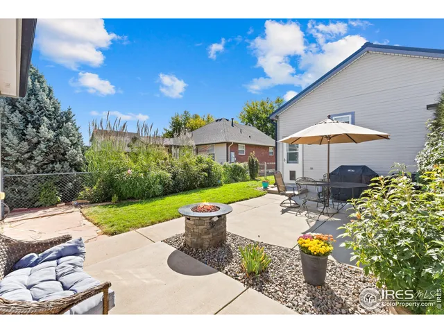 a backyard of a house with table and chairs