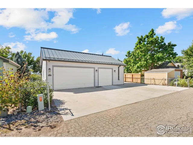 a view of a house with a yard and garage