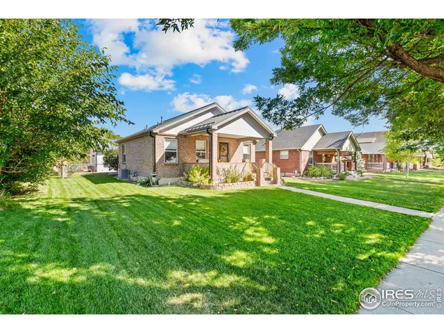 a view of a patio with couches table and chairs and potted plants