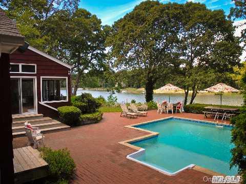 a view of a house with backyard porch and sitting area