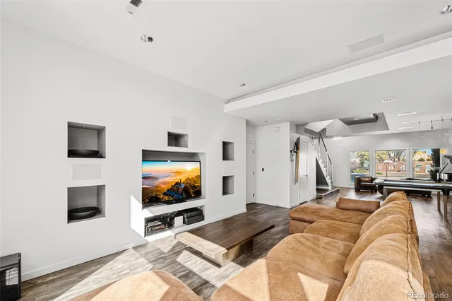 a living room with a flat screen tv and a couch