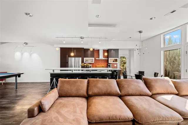 a living room with furniture and kitchen