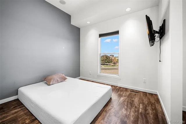 a bedroom with a large bed and a window