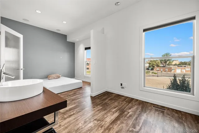 a view of a workspace with furniture and window