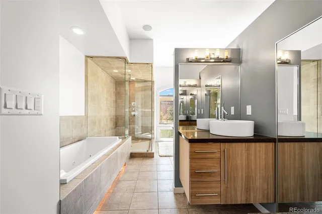a bathroom with a granite countertop sink and a bathtub