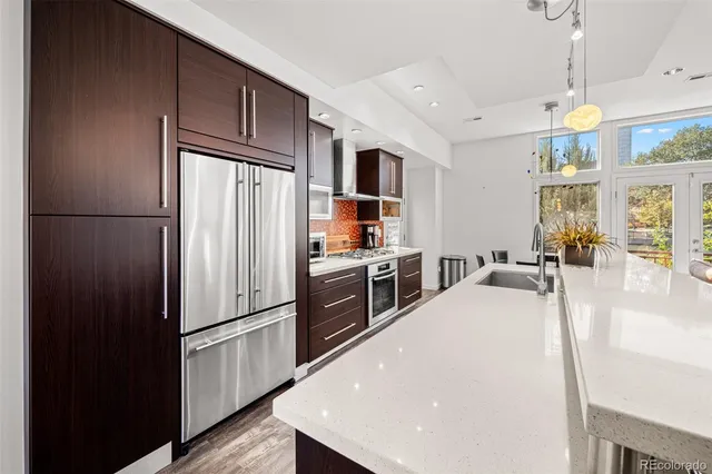 a kitchen with stainless steel appliances a refrigerator and a stove