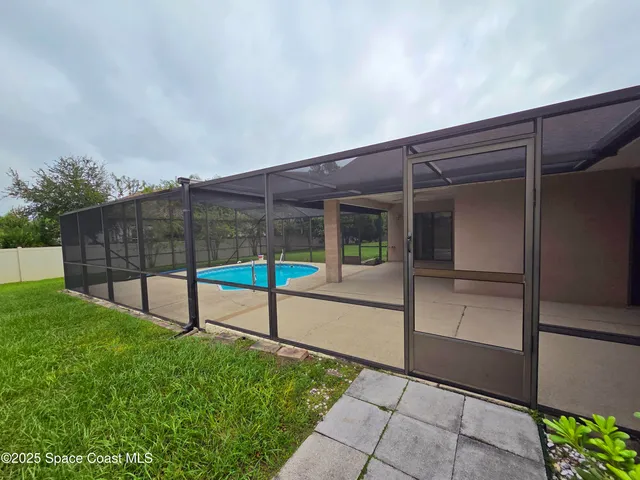 a view of a garden with a building in the background
