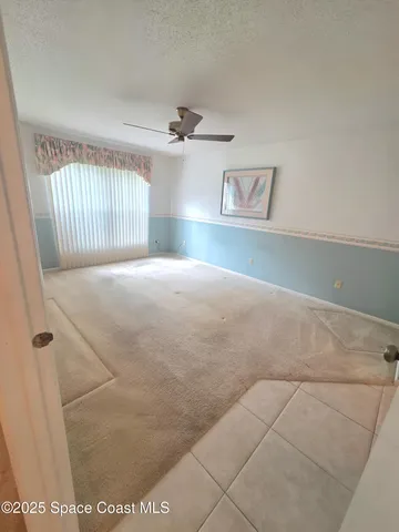 a large bed sitting in a bedroom next to a window