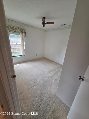 a view of a hallway with wooden floor and entryway