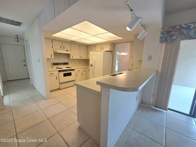 a large kitchen with cabinets and stainless steel appliances