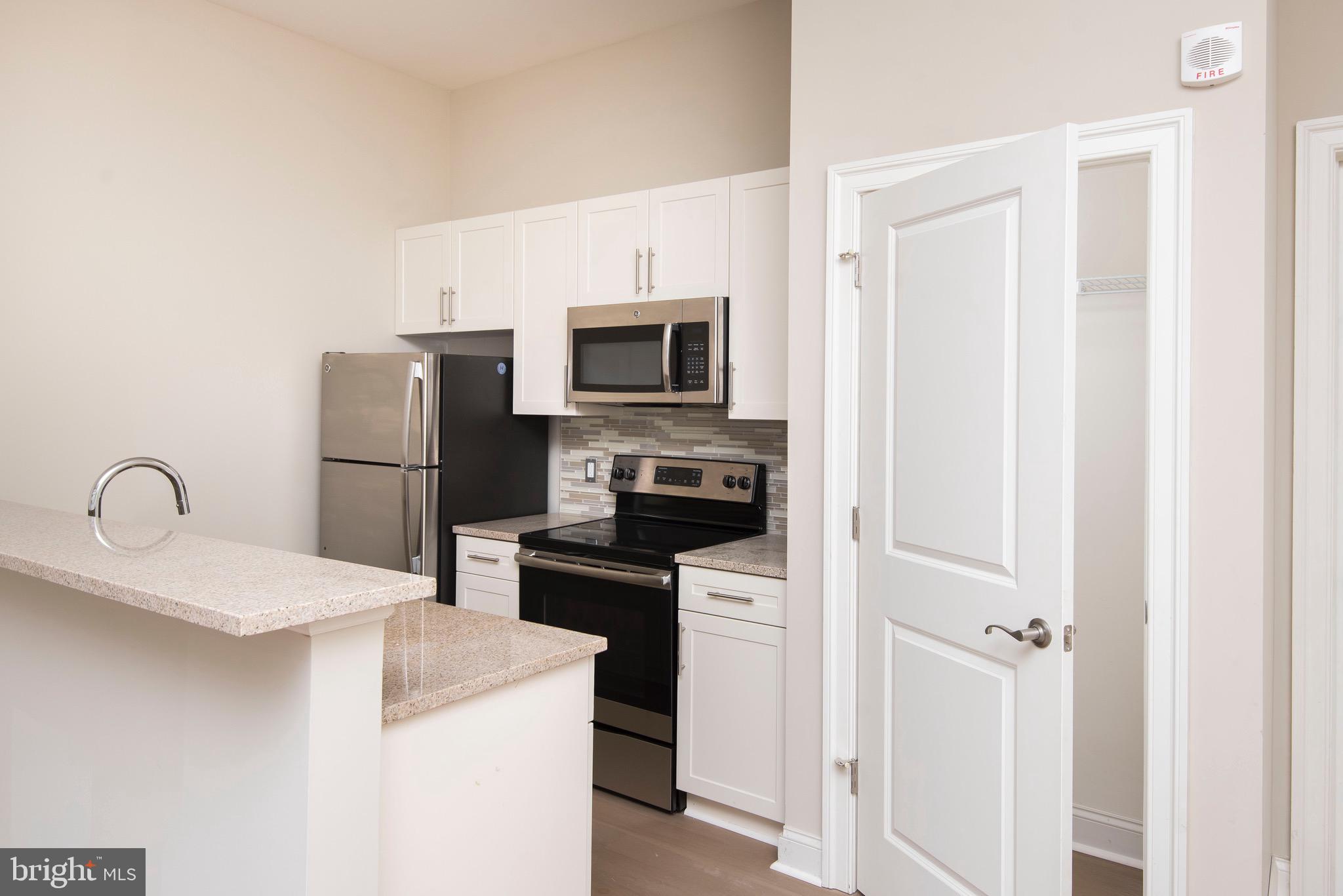 103 South Gay Street, Unit 1BR Baltimore, MD 21202 - Photo 43 of 92 a kitchen with a refrigerator and a sink