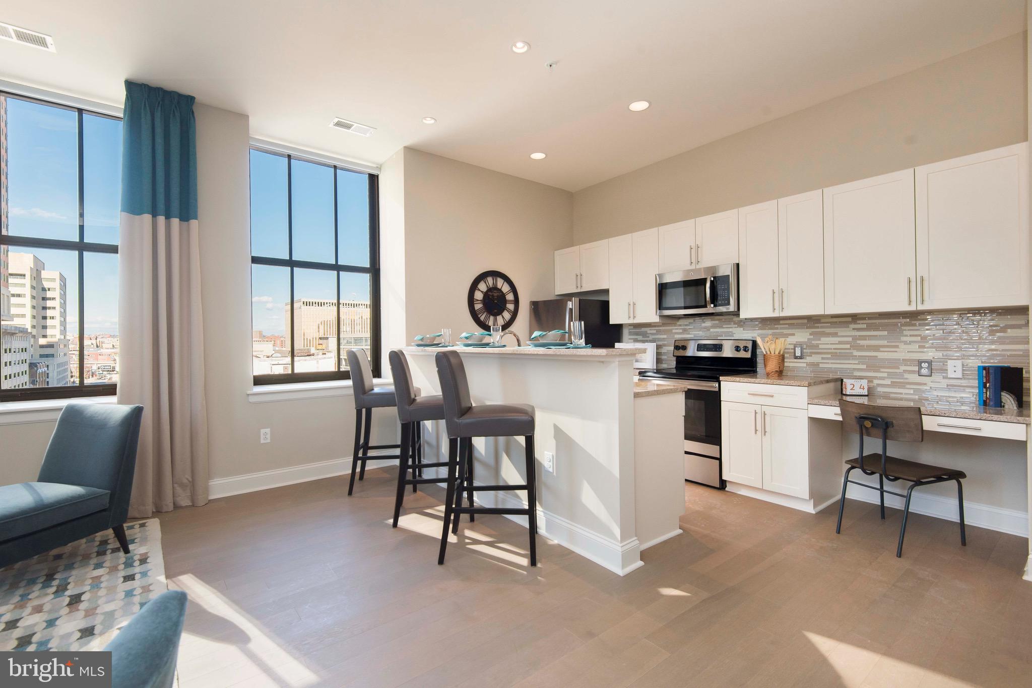 103 South Gay Street, Unit 1BR Baltimore, MD 21202 - Photo 53 of 92 a kitchen with white cabinets and stainless steel appliances